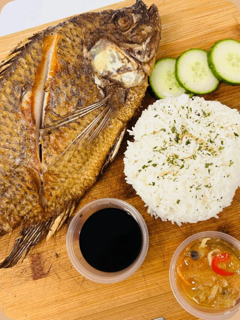 Whole grilled tilapia with rice and dipping sauce