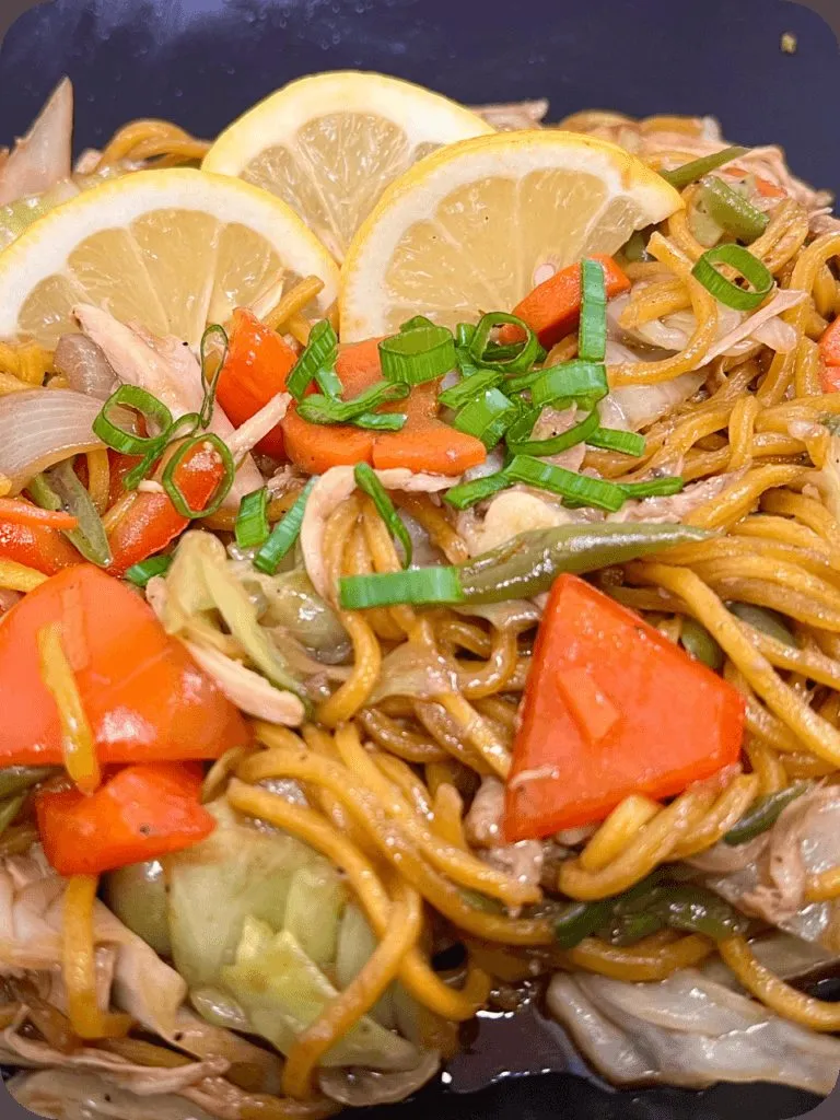 Pancit canton noodles with vegetables and lemon