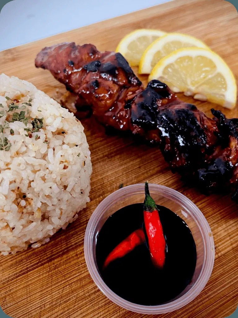 Filipino pork barbecue skewer with rice and dipping sauce